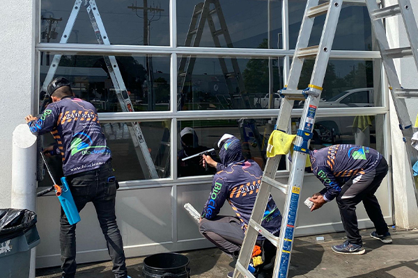 A group of men cleaning a window