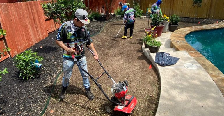 Biocleaners USA staff cleaning and maintaining a beautiful garden in a residential home.